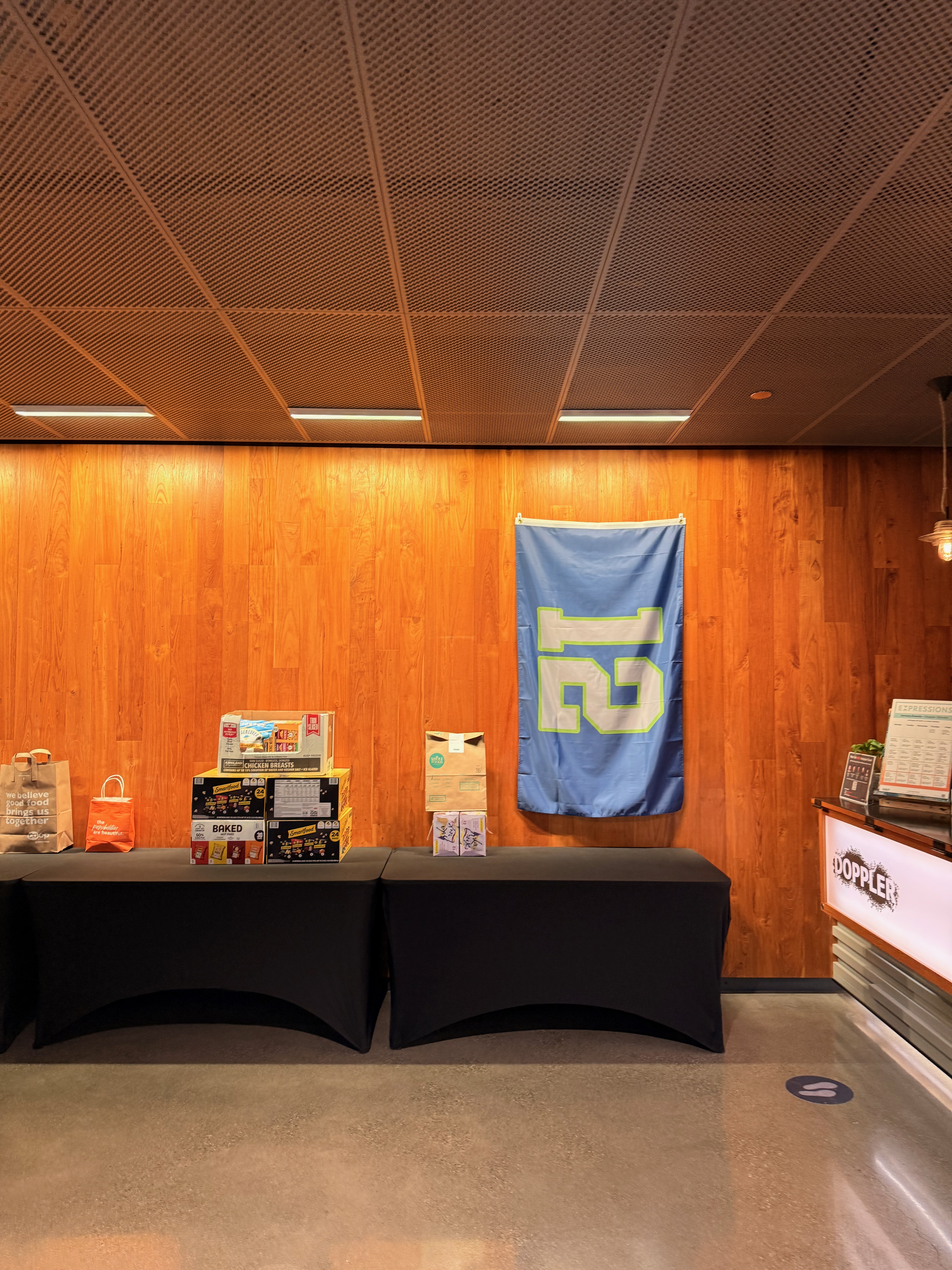 A 12 flag hanging on the wall in the office lobby